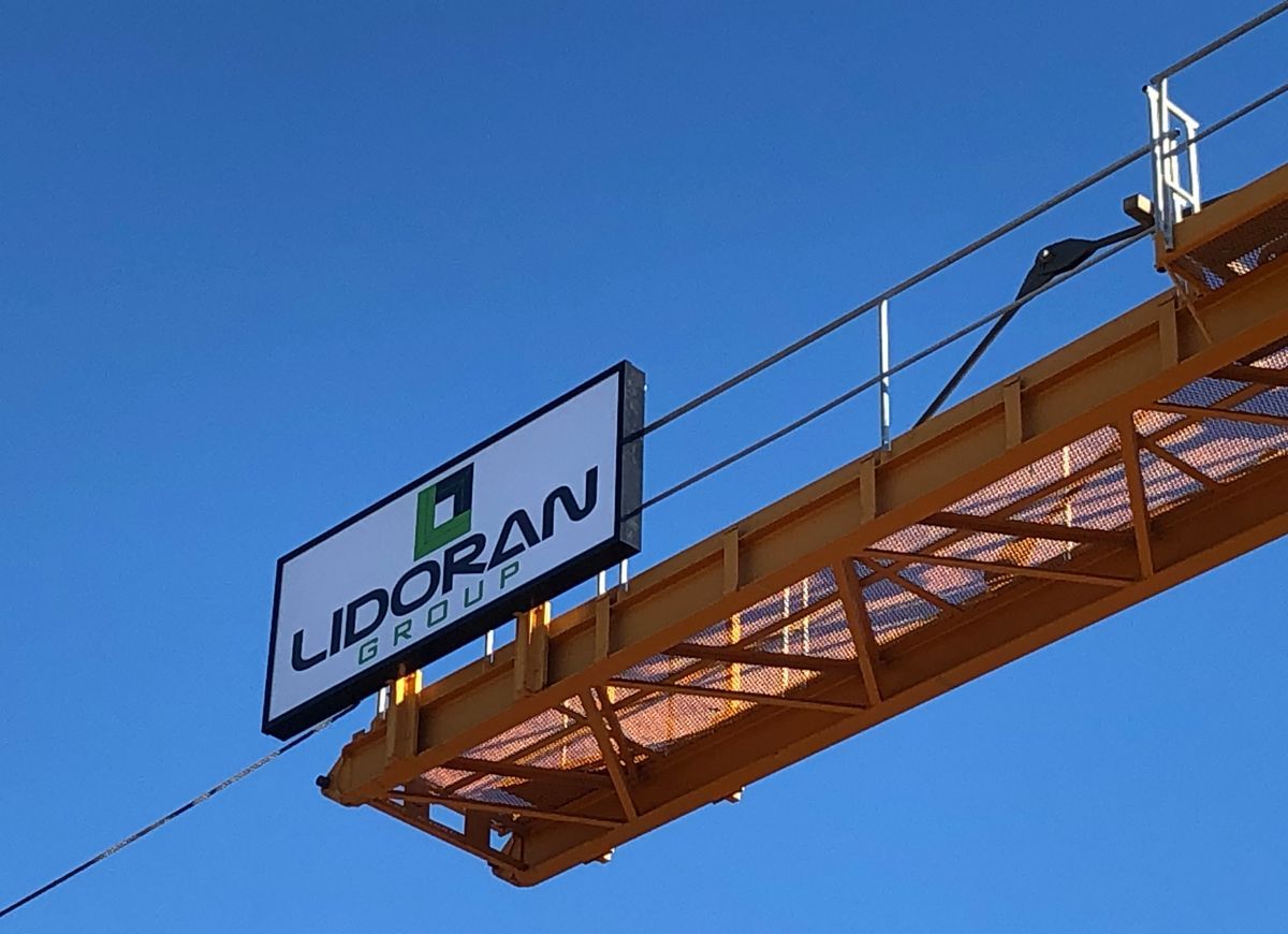 About Lidoran Group Industrial crane equipment in blue sky with Lidoran Group sign