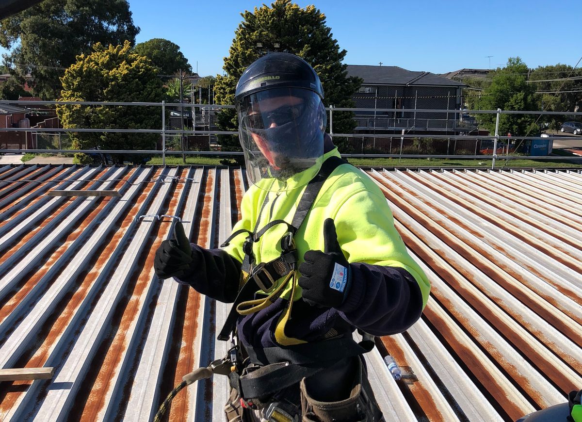 About Lidoran Roofing Lidoran Roofing team member in safety gear on roof and ready to start reroofing job